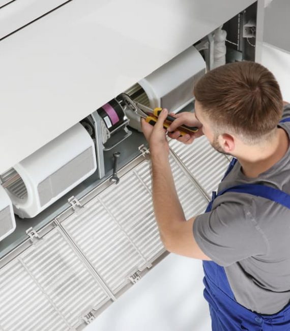 Aircon technician fixing air conditioner blower — Air Conditioning on the Sunshine Coast, QLD